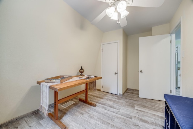 office with ceiling fan and light hardwood / wood-style floors