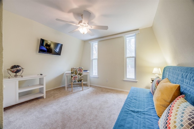 living area featuring light carpet and ceiling fan