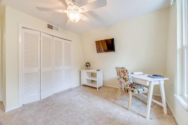 office space with light colored carpet and ceiling fan