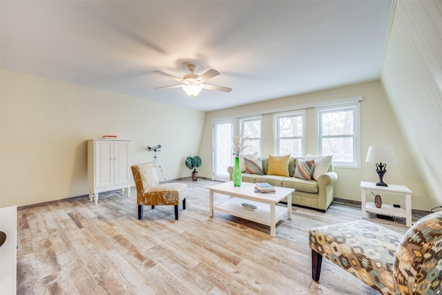 living room with a wealth of natural light, ceiling fan, and light hardwood / wood-style flooring