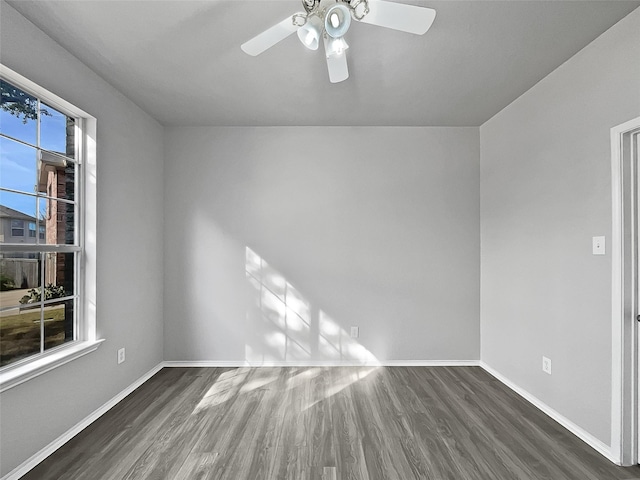 unfurnished room featuring ceiling fan and dark wood-type flooring