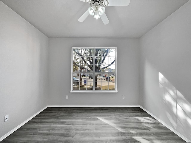 spare room featuring dark hardwood / wood-style floors and ceiling fan