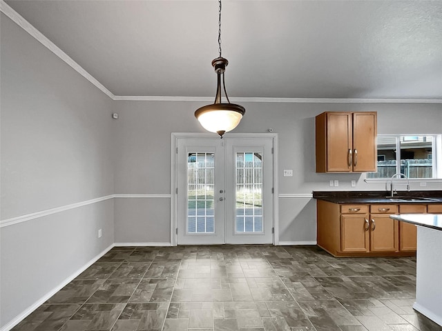 kitchen featuring pendant lighting, french doors, crown molding, and sink