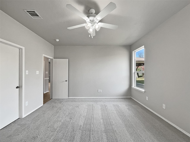 carpeted empty room featuring ceiling fan