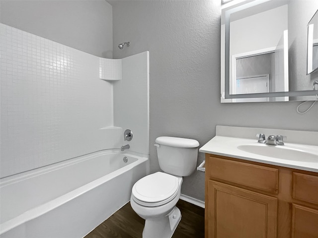 full bathroom with hardwood / wood-style flooring, vanity, toilet, and washtub / shower combination