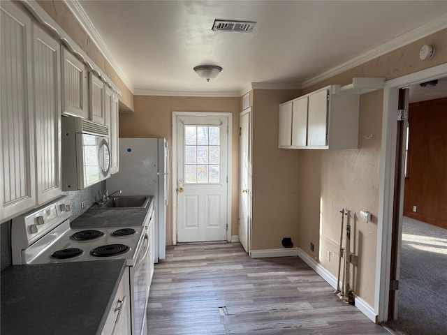 kitchen featuring white appliances, white cabinets, sink, crown molding, and light hardwood / wood-style floors