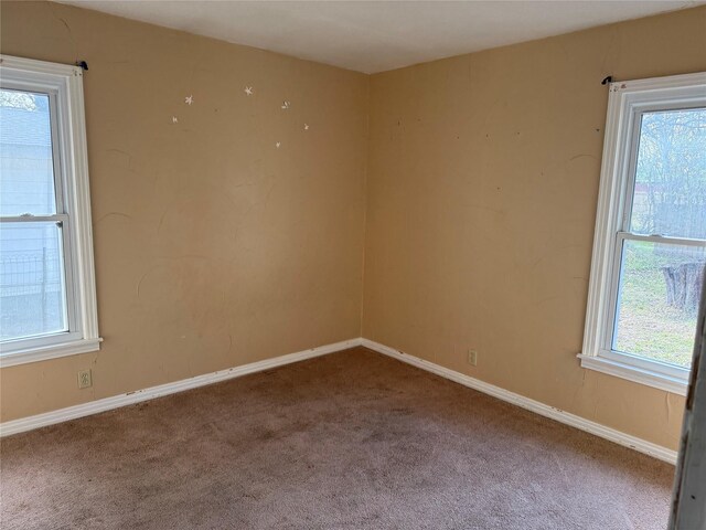 carpeted spare room with a healthy amount of sunlight