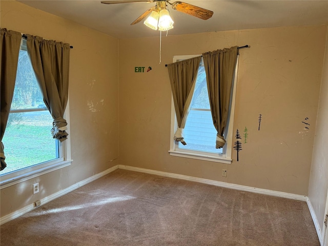 carpeted spare room featuring ceiling fan