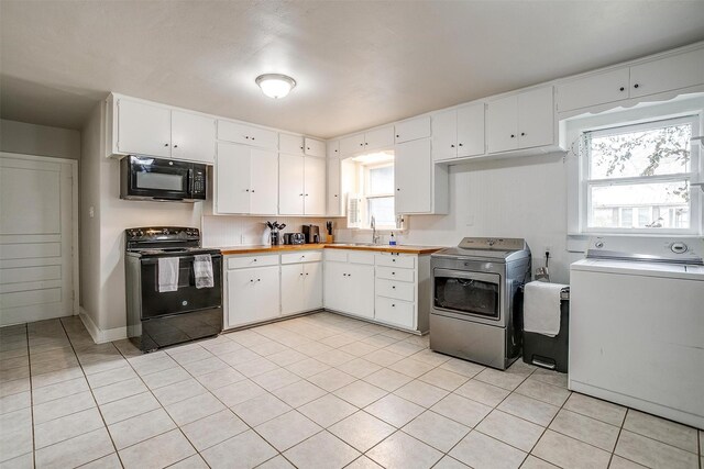 kitchen featuring black appliances, sink, independent washer and dryer, light tile patterned floors, and white cabinetry