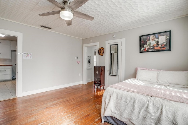 bedroom featuring light hardwood / wood-style flooring and ceiling fan