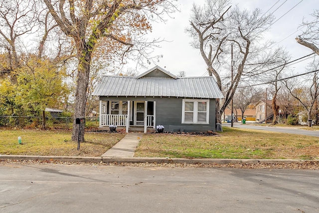 bungalow-style house featuring a porch and a front yard