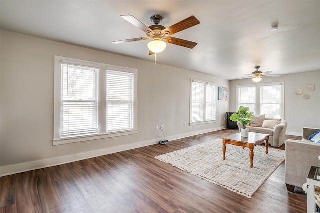 living room featuring ceiling fan and dark hardwood / wood-style flooring