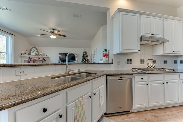 kitchen with white cabinets, stainless steel appliances, lofted ceiling, and sink