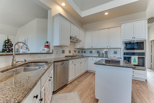 kitchen featuring light stone countertops, white cabinetry, sink, stainless steel appliances, and tasteful backsplash