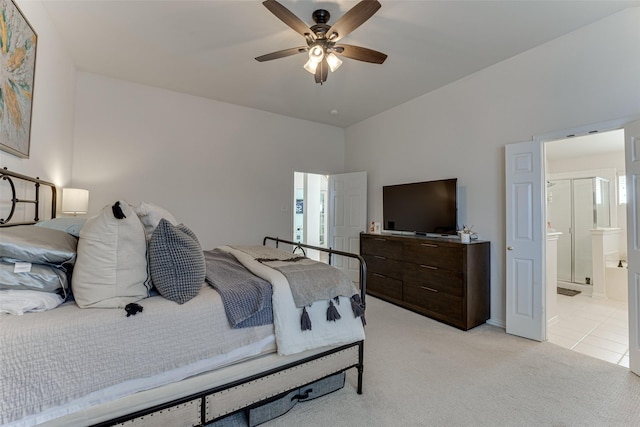 carpeted bedroom featuring connected bathroom and ceiling fan