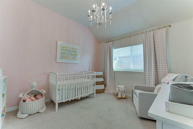 bedroom featuring vaulted ceiling, light colored carpet, a crib, and an inviting chandelier