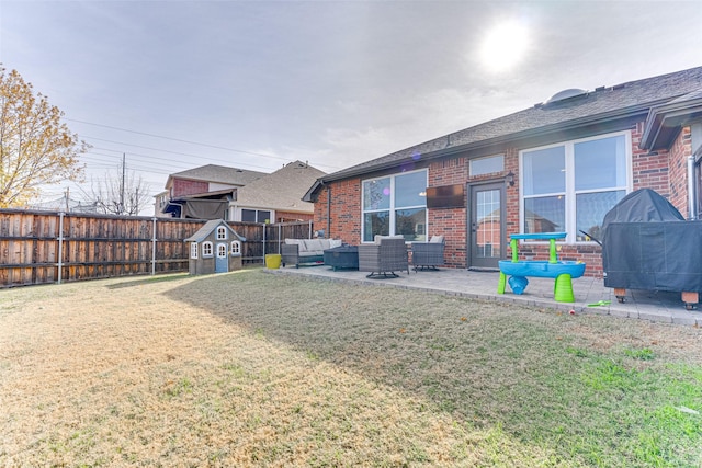 exterior space with outdoor lounge area, a storage shed, and a patio