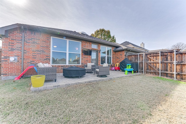 rear view of property with a lawn and a patio area