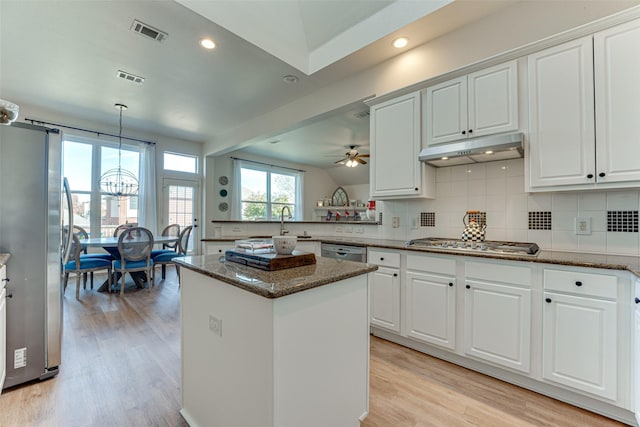 kitchen with white cabinets, light wood-type flooring, kitchen peninsula, and appliances with stainless steel finishes