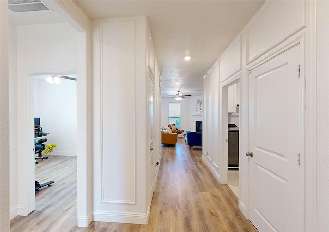 corridor featuring light hardwood / wood-style floors