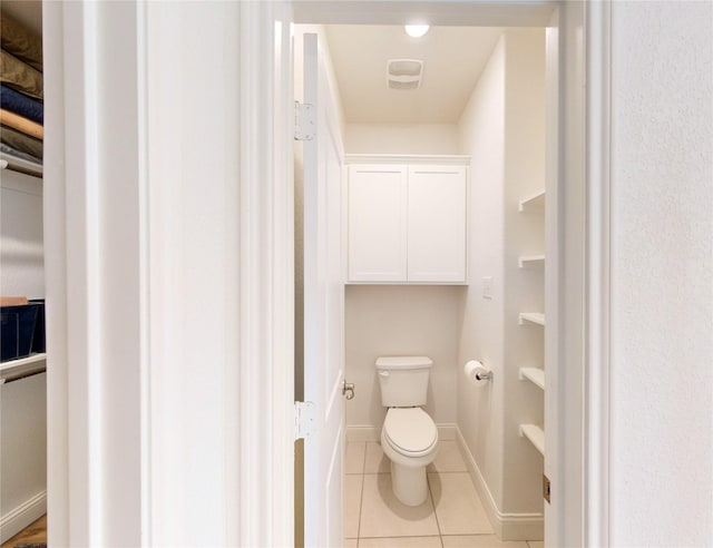 bathroom with tile patterned flooring and toilet