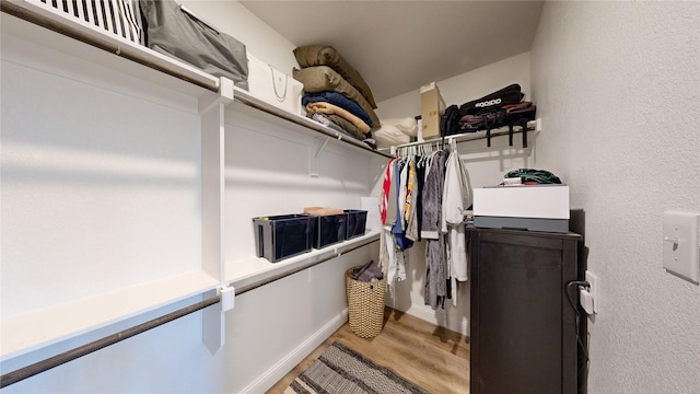 spacious closet featuring hardwood / wood-style floors