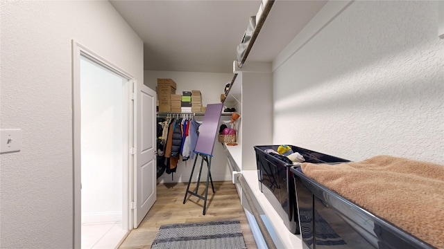 spacious closet featuring light wood-type flooring