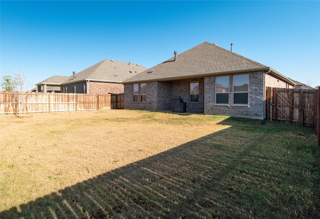 back of property featuring a lawn