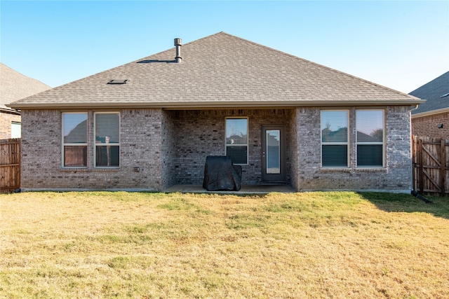 back of house featuring a yard