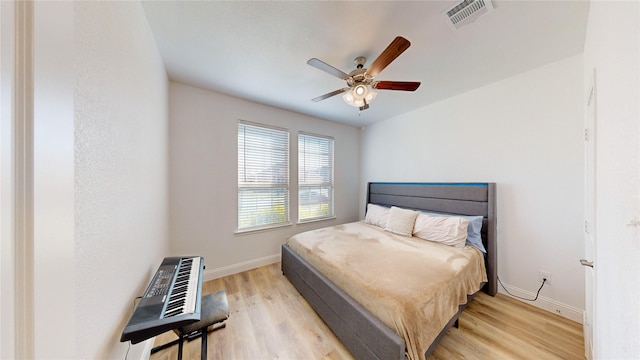 bedroom with ceiling fan and light hardwood / wood-style flooring