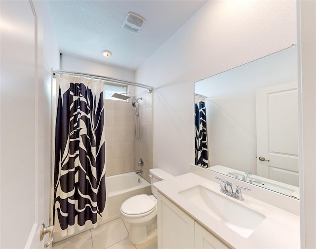 full bathroom featuring vanity, a textured ceiling, tile patterned floors, toilet, and shower / bath combo with shower curtain