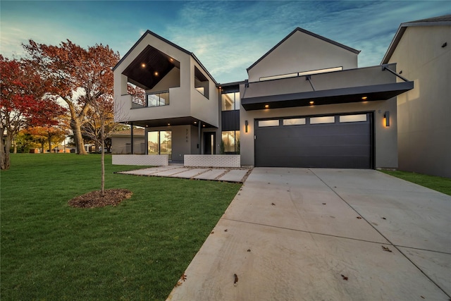 contemporary house with a lawn and a balcony