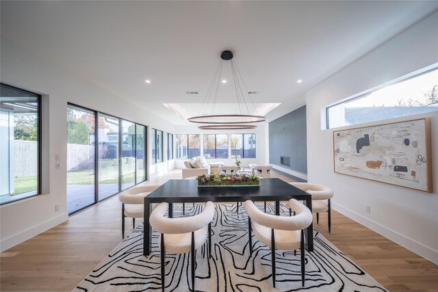 dining area featuring light hardwood / wood-style floors and a notable chandelier