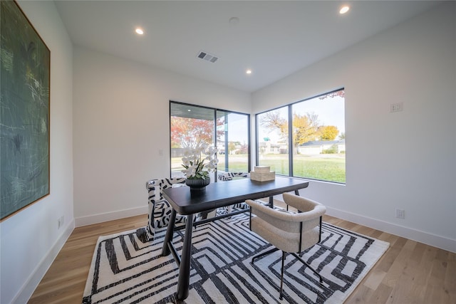 home office with light hardwood / wood-style floors