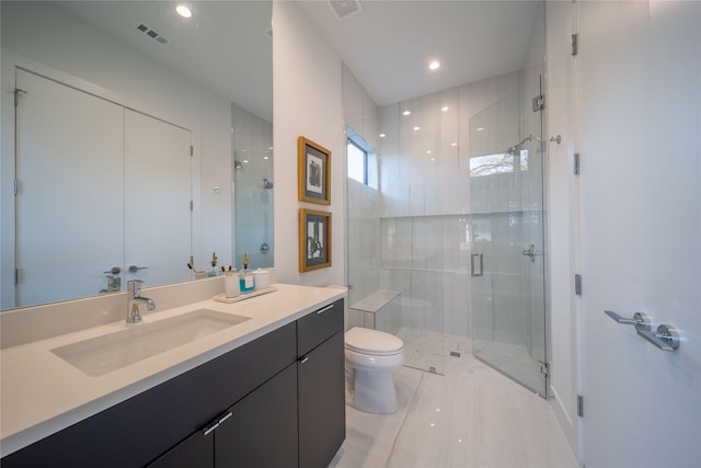 bathroom featuring vanity, toilet, and an enclosed shower