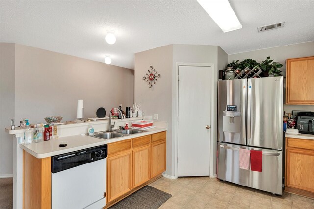 kitchen featuring kitchen peninsula, stainless steel fridge, dishwasher, and sink