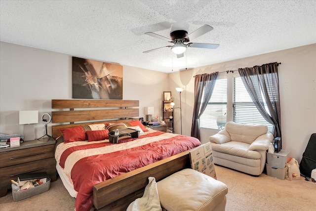 bedroom with light carpet, ceiling fan, and a textured ceiling