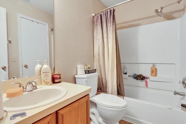 full bathroom with a textured ceiling, vanity, shower / tub combo, and toilet