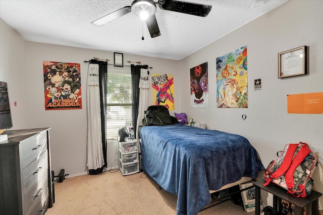 carpeted bedroom featuring ceiling fan and a textured ceiling