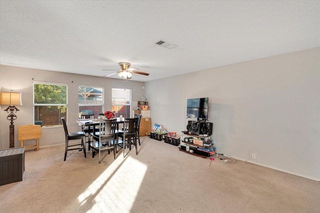 carpeted dining area featuring ceiling fan