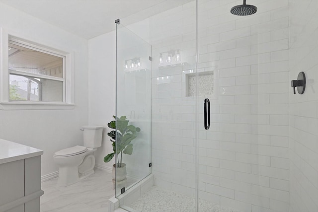 bathroom featuring walk in shower, vanity, and toilet