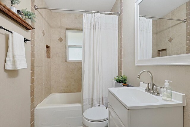 full bathroom featuring shower / bath combination with curtain, vanity, and toilet