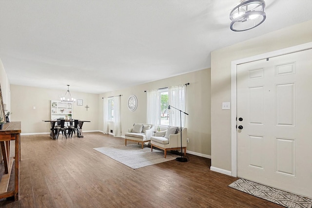 foyer featuring dark hardwood / wood-style floors and an inviting chandelier