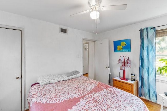 bedroom with visible vents, ceiling fan, and wood finished floors