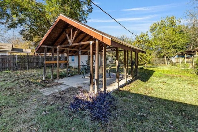 view of property's community with a storage unit and a lawn