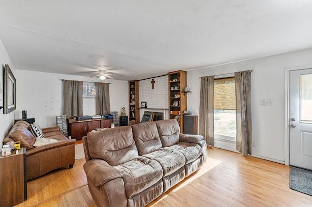 living area featuring ceiling fan and light wood finished floors