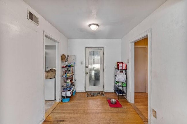 foyer entrance featuring visible vents and wood finished floors