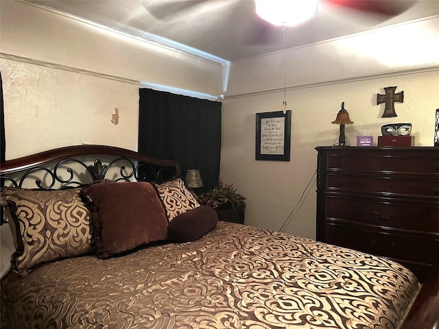 bedroom with ceiling fan and ornamental molding