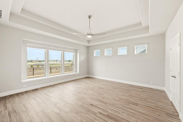 carpeted bedroom with a tray ceiling