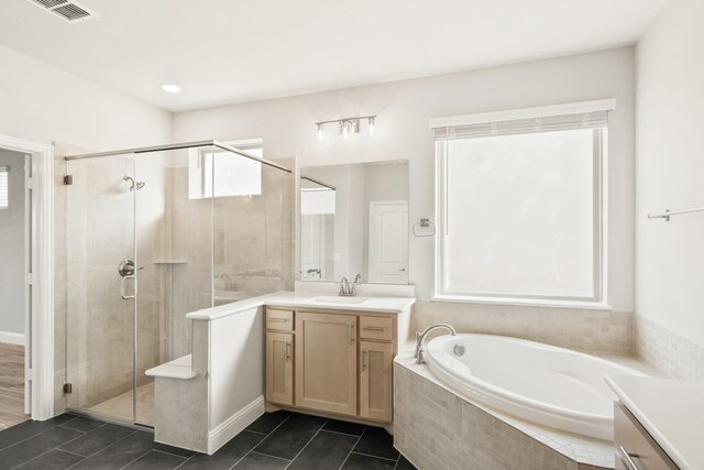 bathroom with vanity and separate shower and tub